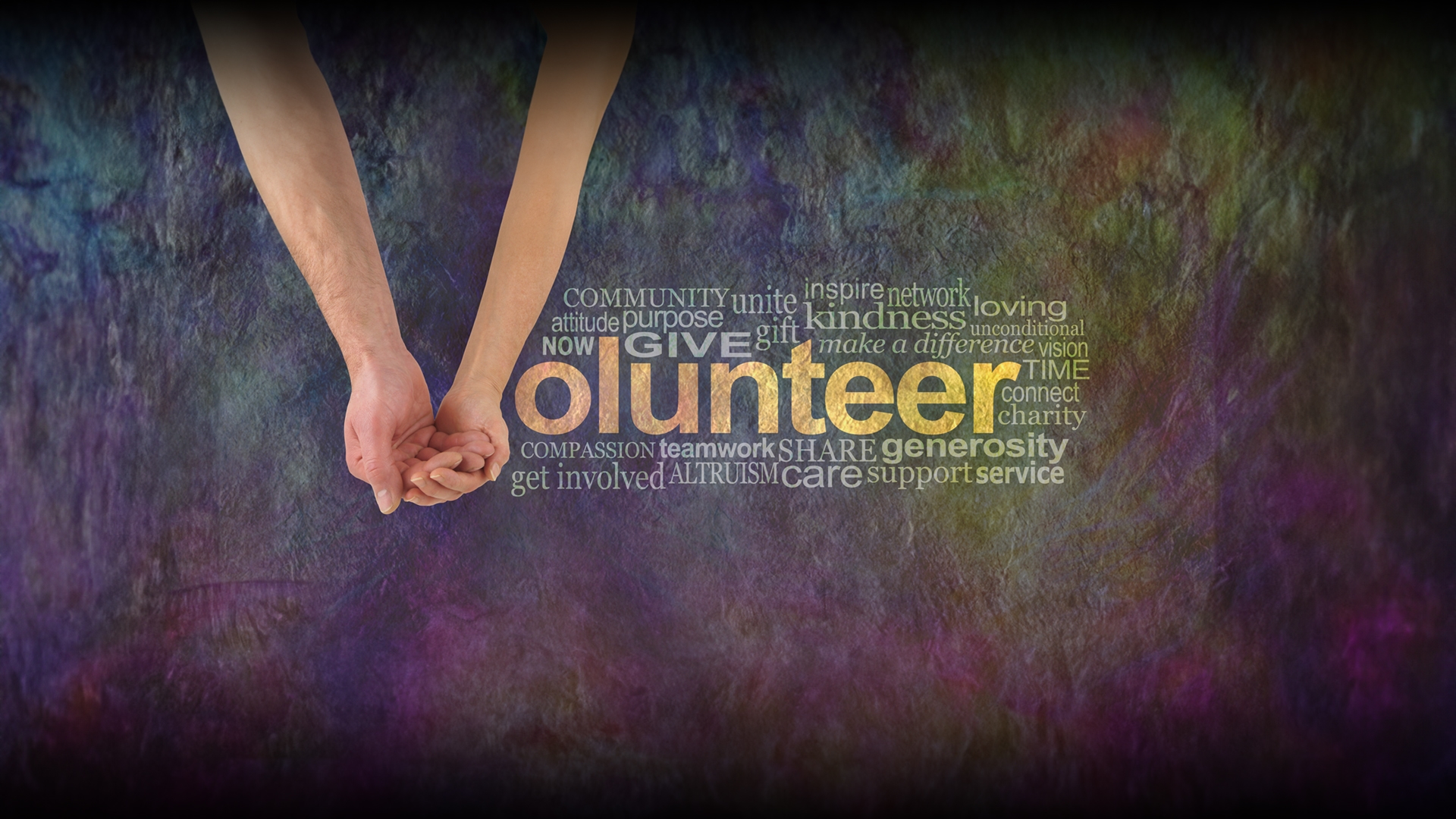 We can volunteer together - male hand cupped by a female hand making the V of VOLUNTEER surrounded by a word cloud