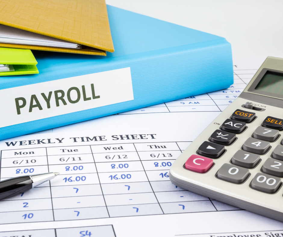binders and calculator labeled payroll